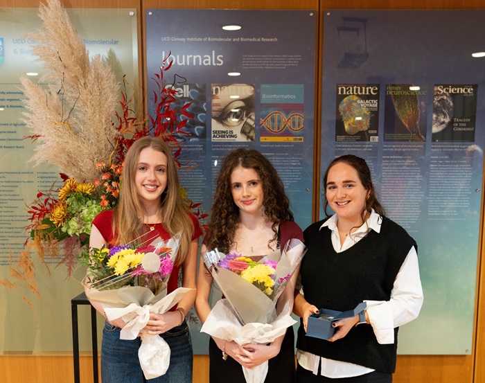Girls smiling holding flowers
